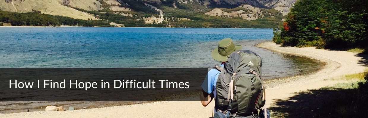 Finding Hope in Difficult Times_Featured T. A. standing beside a lake, looking off in the distance to symbolize finding hope