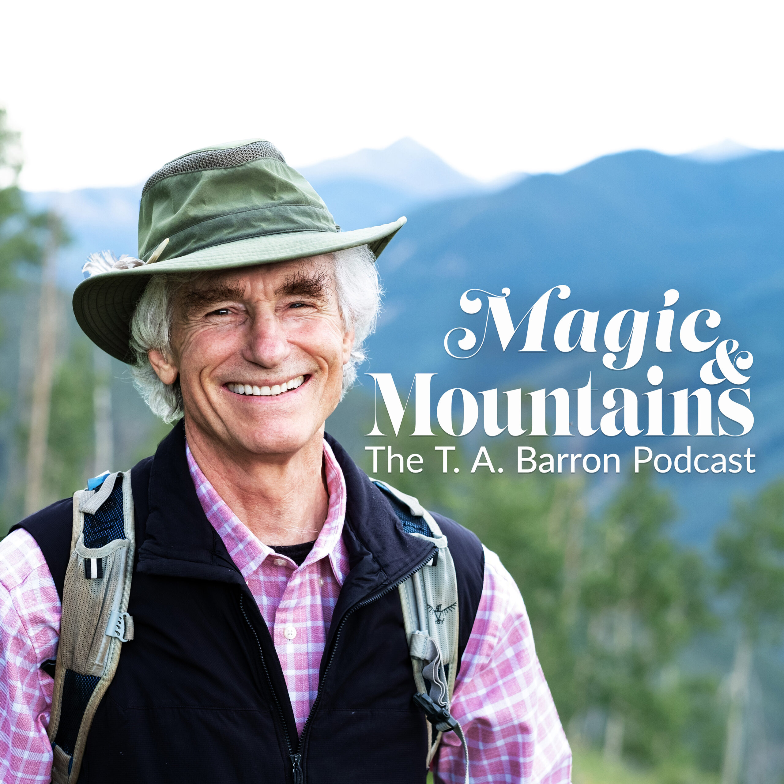 Man with Hat standing in front of mountains and trees