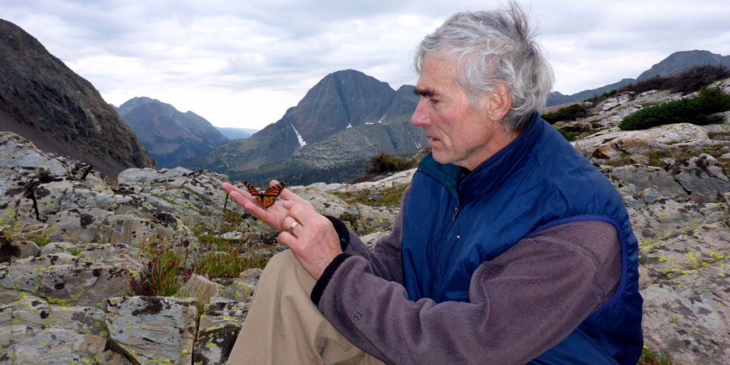 T. A. Barron with a monarch butterfly on a mountain