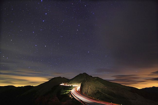 Starry night above a mountain highway